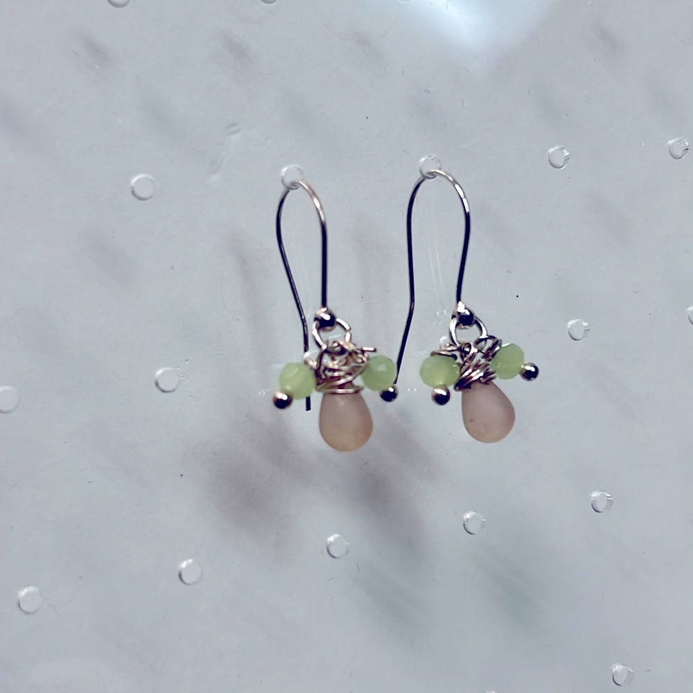Sterling silver French hook wire earrings with light pink and green dangle.